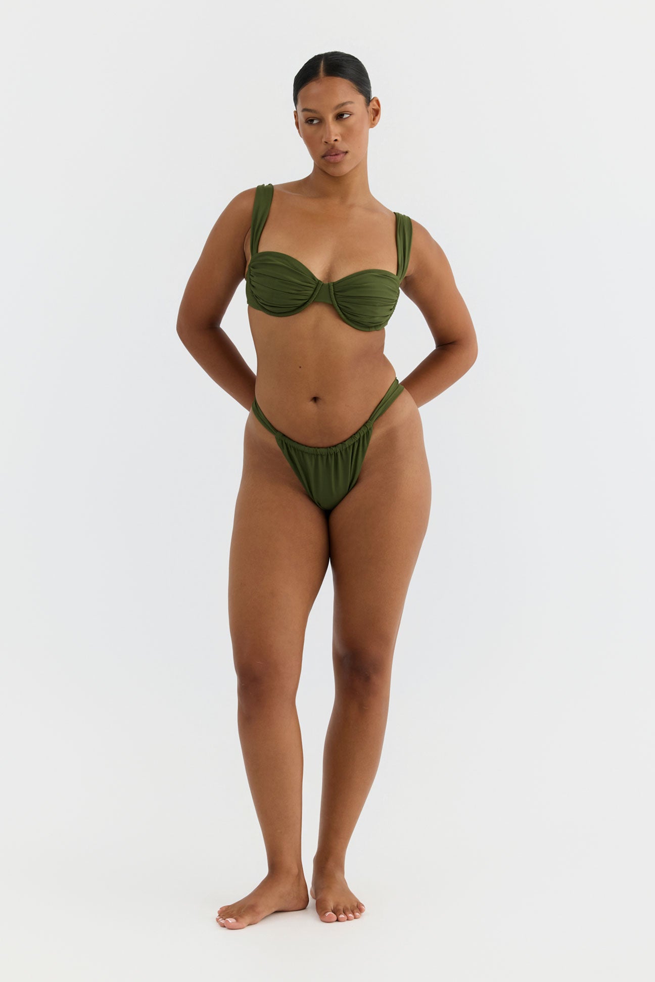 Woman wearing a green bikini on a white background