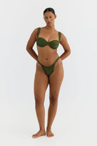 Woman wearing a green bikini on a white background