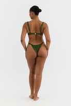 Woman wearing a green bikini on a white background