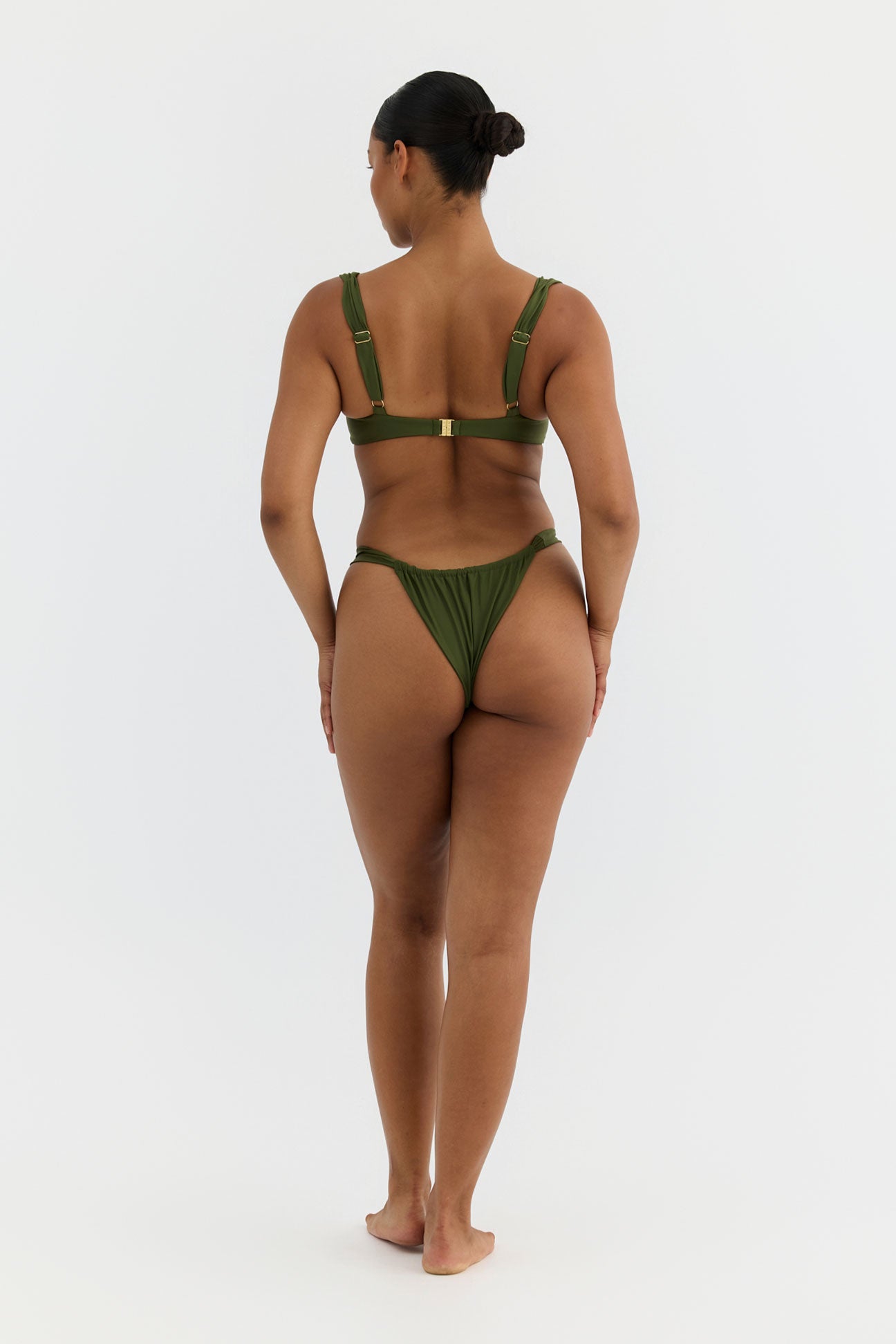 Woman wearing a green bikini on a white background