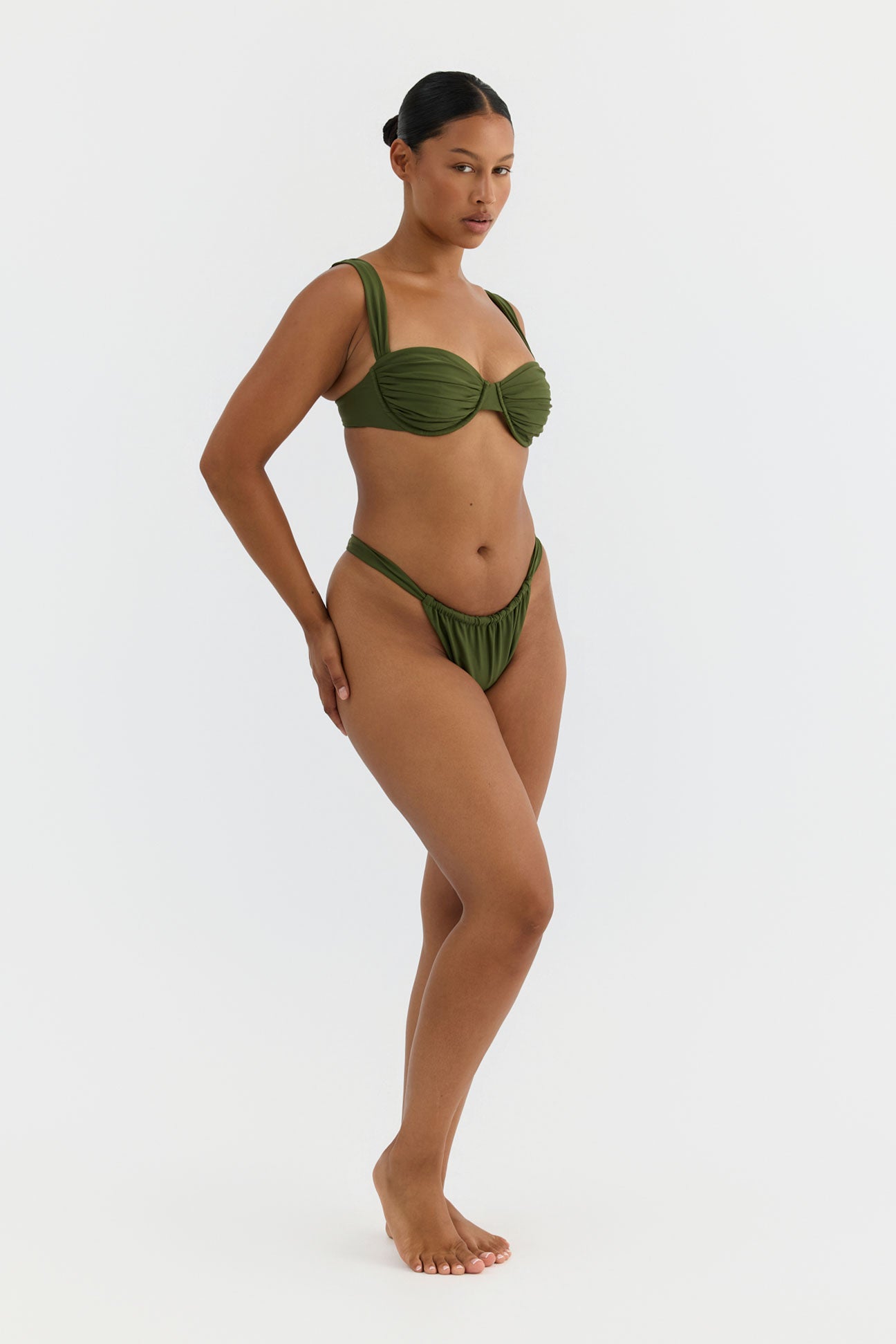 Woman wearing a green bikini on a white background