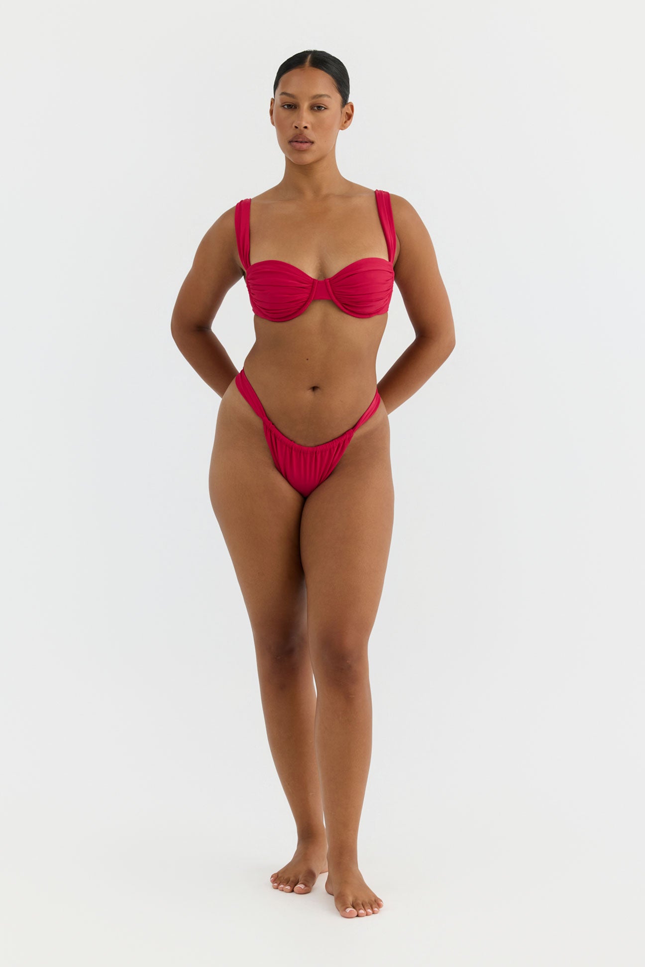 Woman wearing a red bikini on a white background