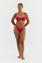 Woman wearing a red bikini on a white background