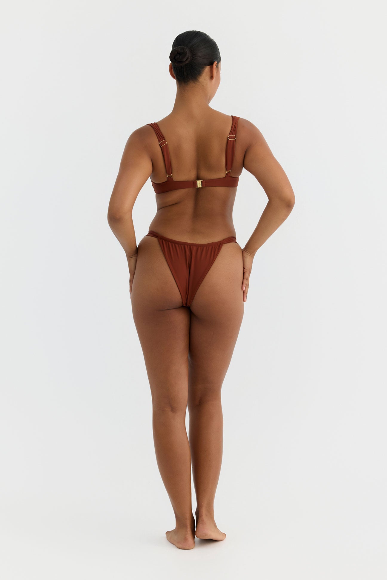 Person wearing a terracotta bikini on a white background