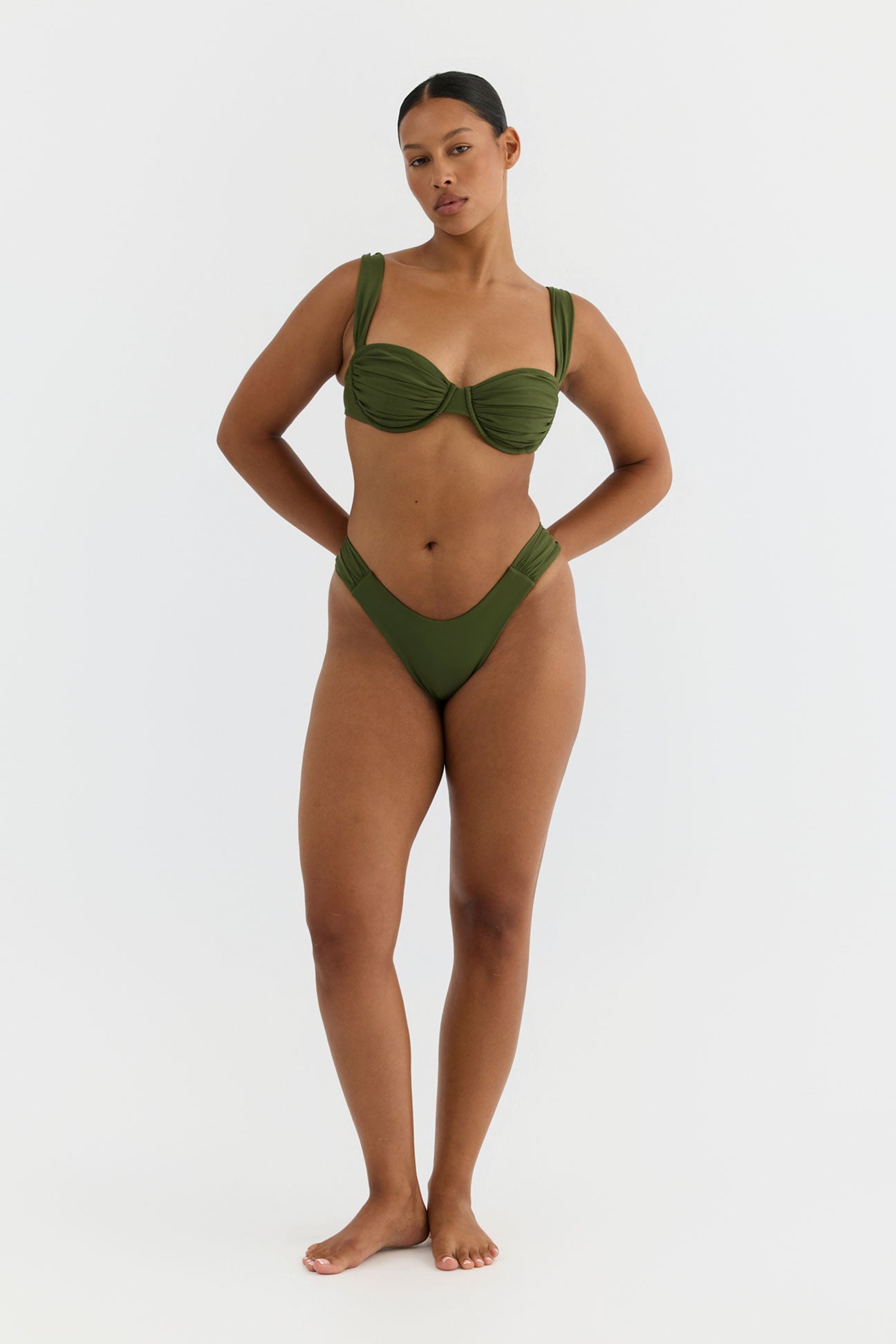 Woman wearing a green bikini on a white background