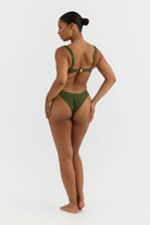 Woman wearing a green bikini on a white background