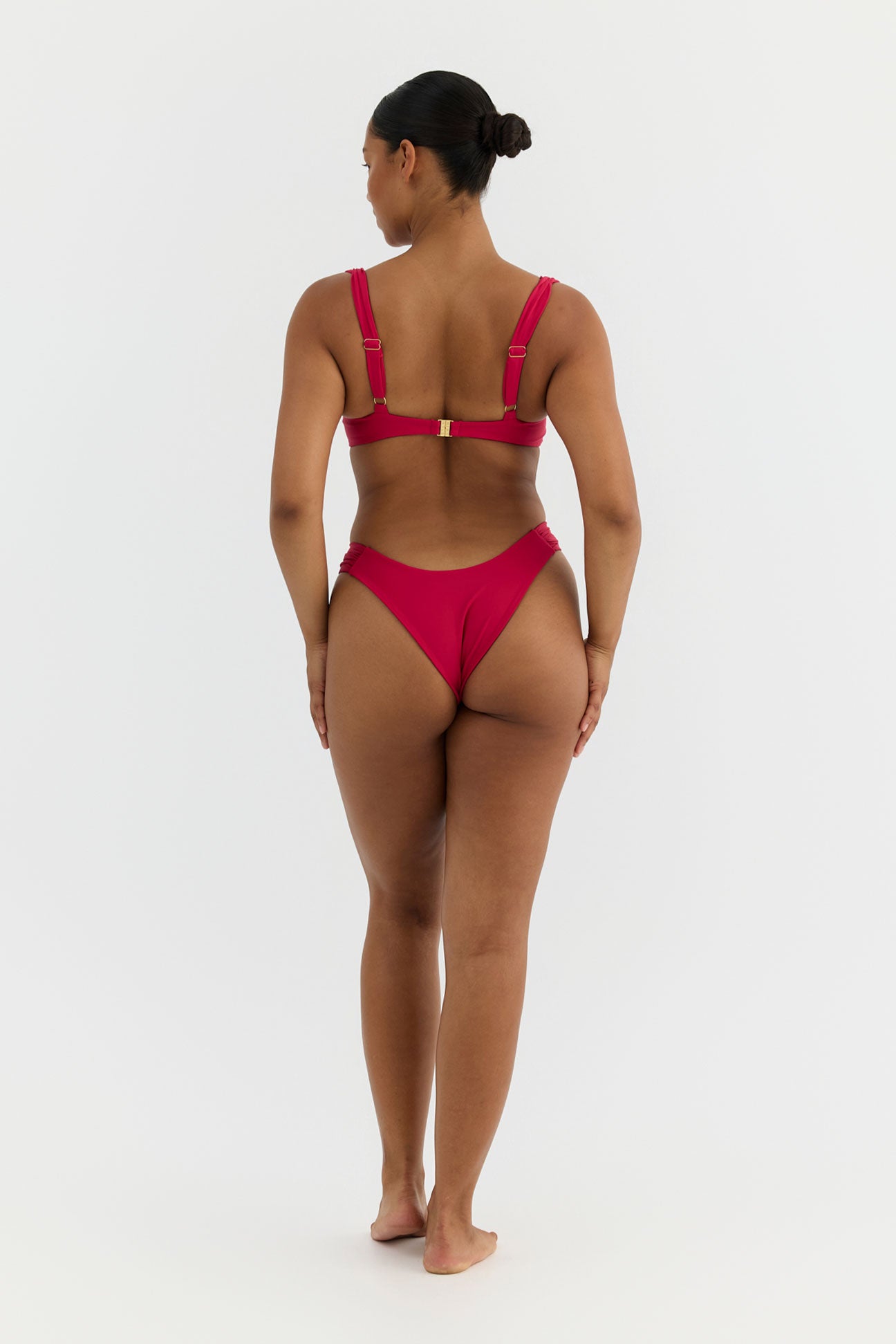 Woman wearing a pink bikini on a white background