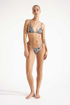 Woman wearing a floral bikini on a white background