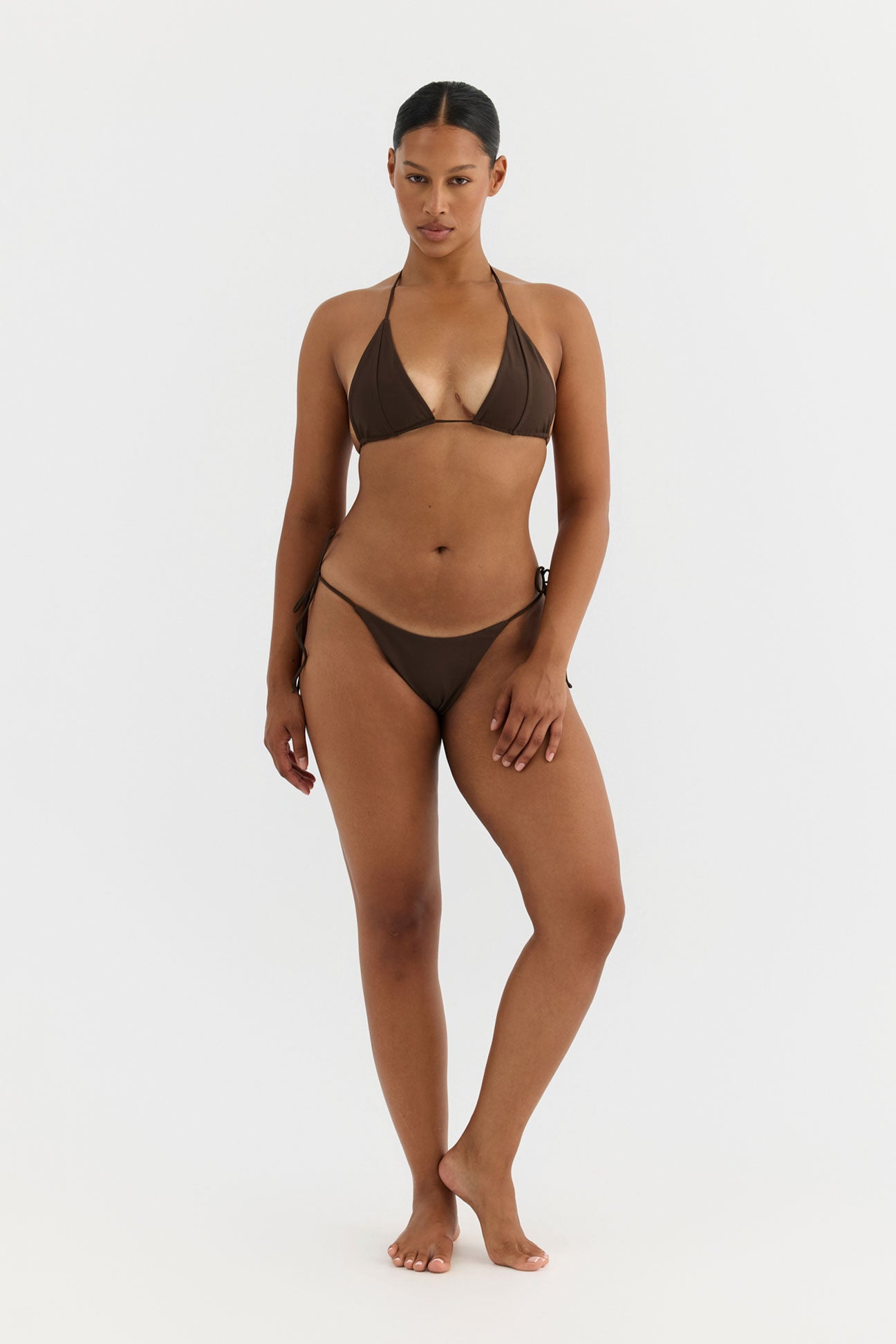 Woman wearing a brown bikini on a white background