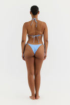 Woman wearing a blue bikini on a white background