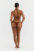Person wearing a terracotta bikini on a white background