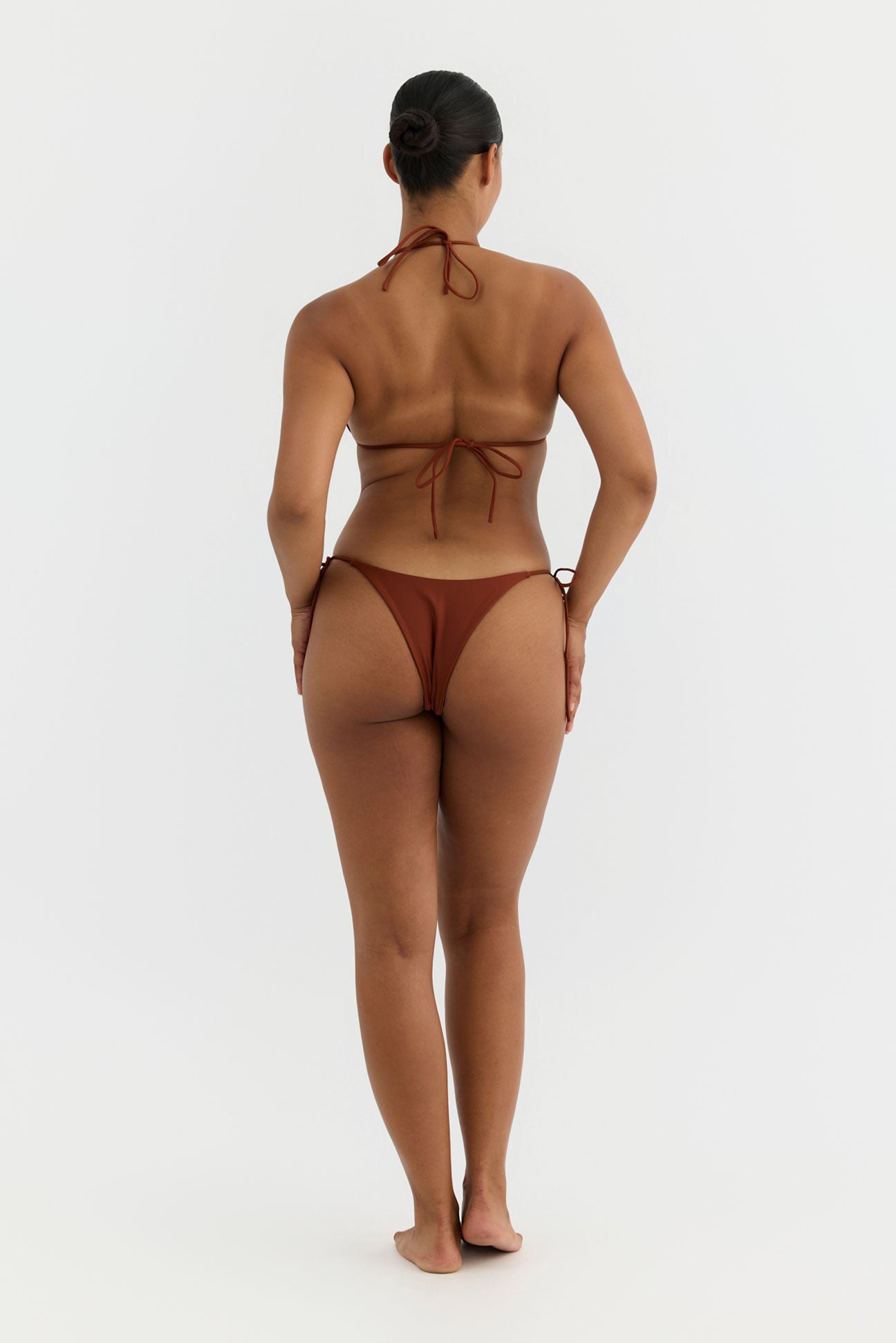 Person wearing a terracotta bikini on a white background