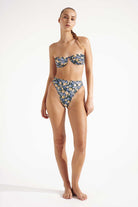 Woman wearing a blue floral bikini on a white background