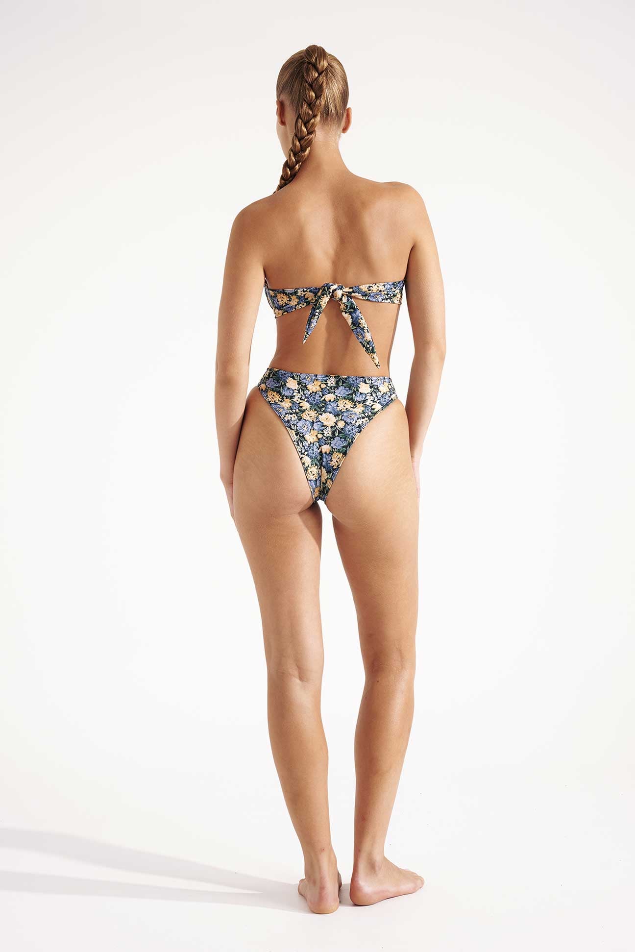 Woman wearing a floral bikini on a white background