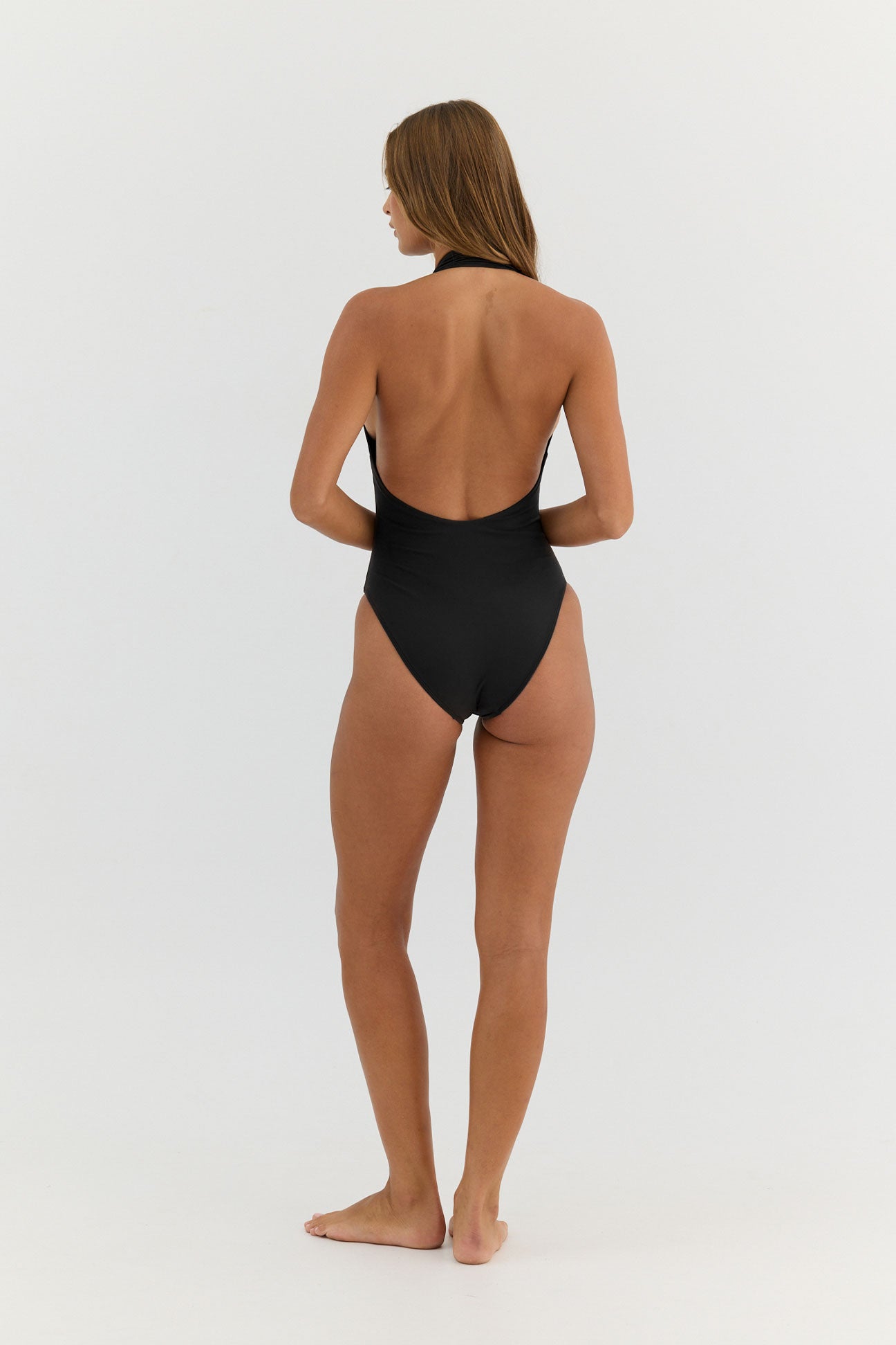 Person wearing a black swimsuit on a white background