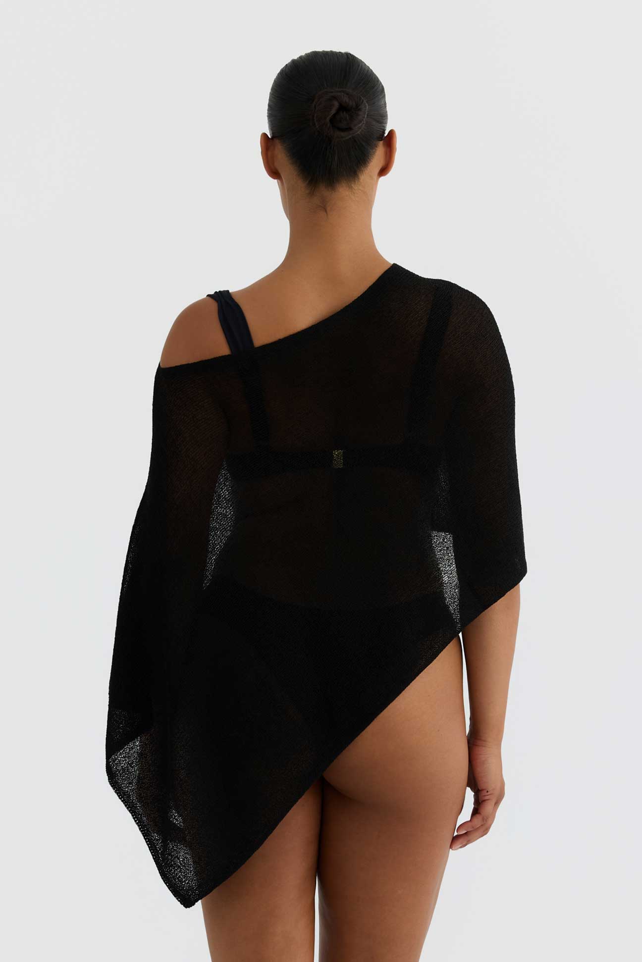 Black sheer garment worn by a model on a white background