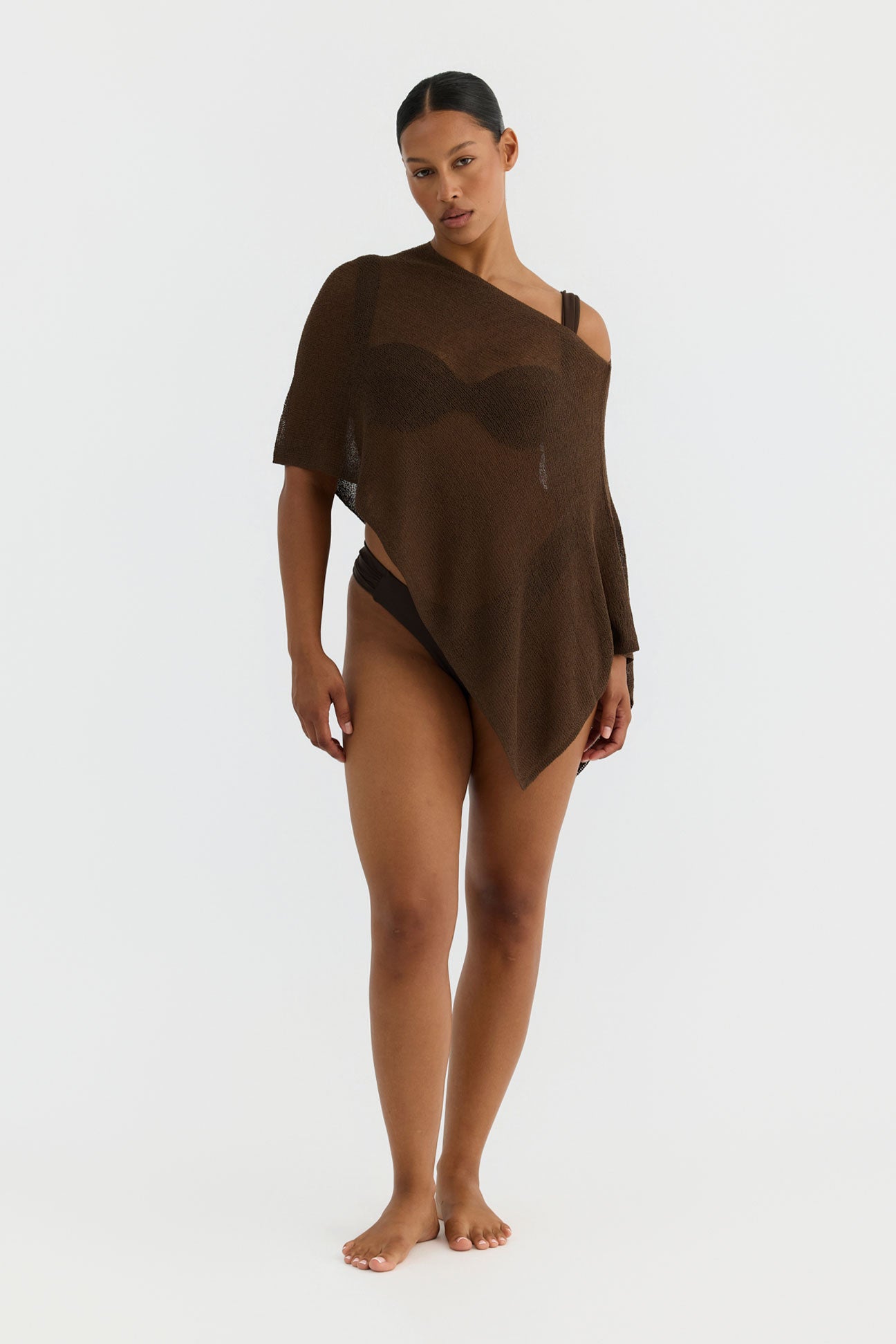 Woman wearing a brown one-shoulder top on a white background