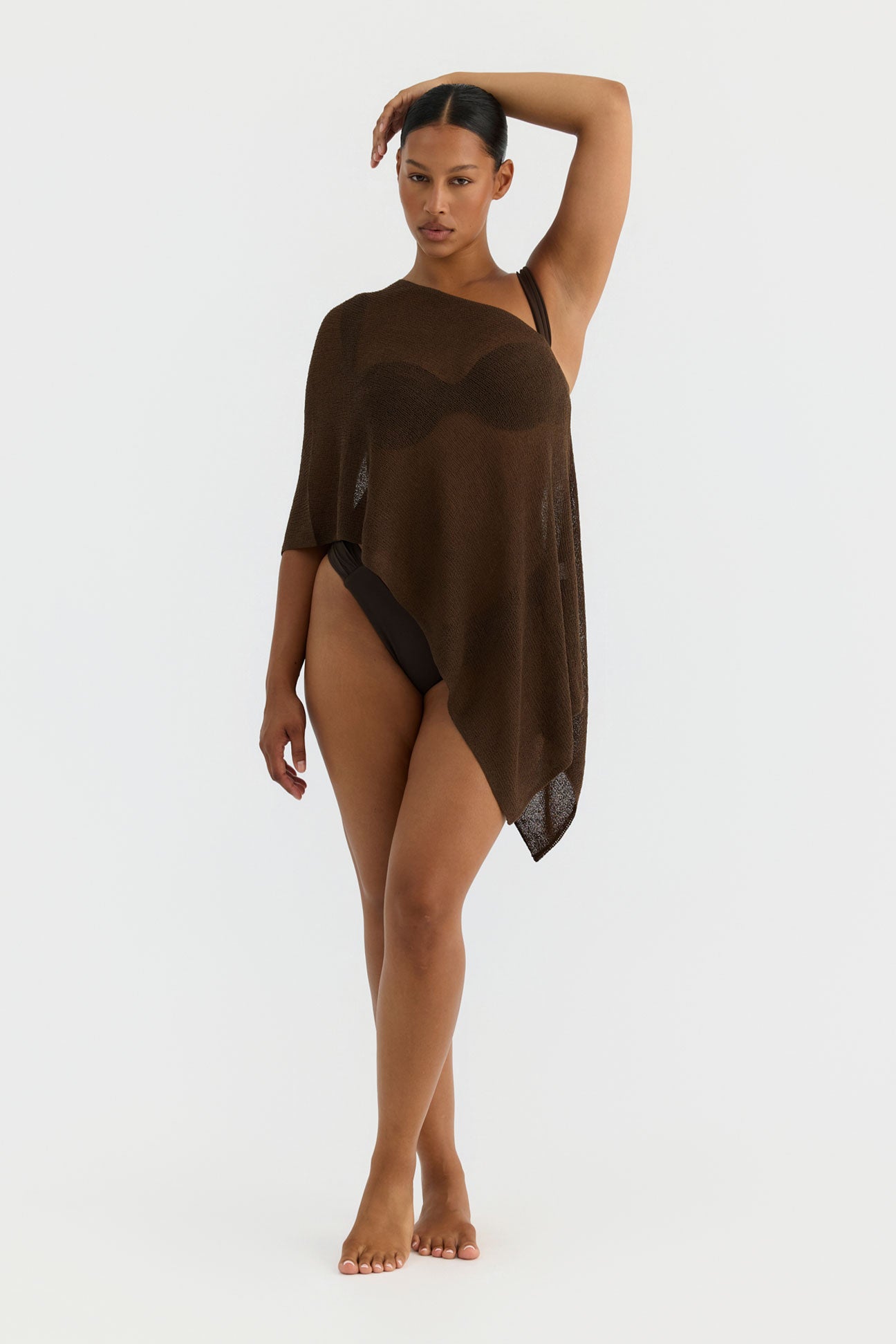 Woman wearing a brown sheer cover-up on a white background