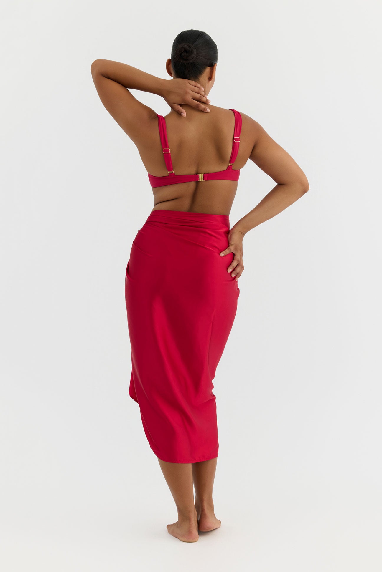 Person wearing a pink swimsuit with a white background