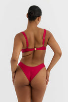 Person wearing a red bikini on a white background