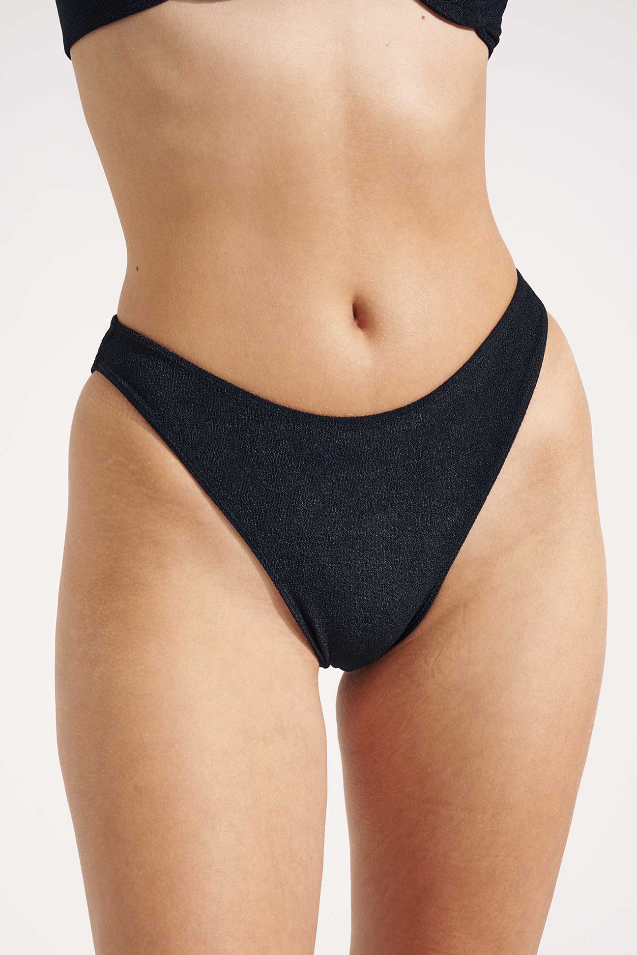 Black bikini bottom on a plain background