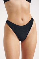 Black bikini bottom on a plain background