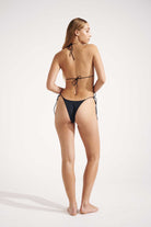 Woman wearing a black bikini on a white background