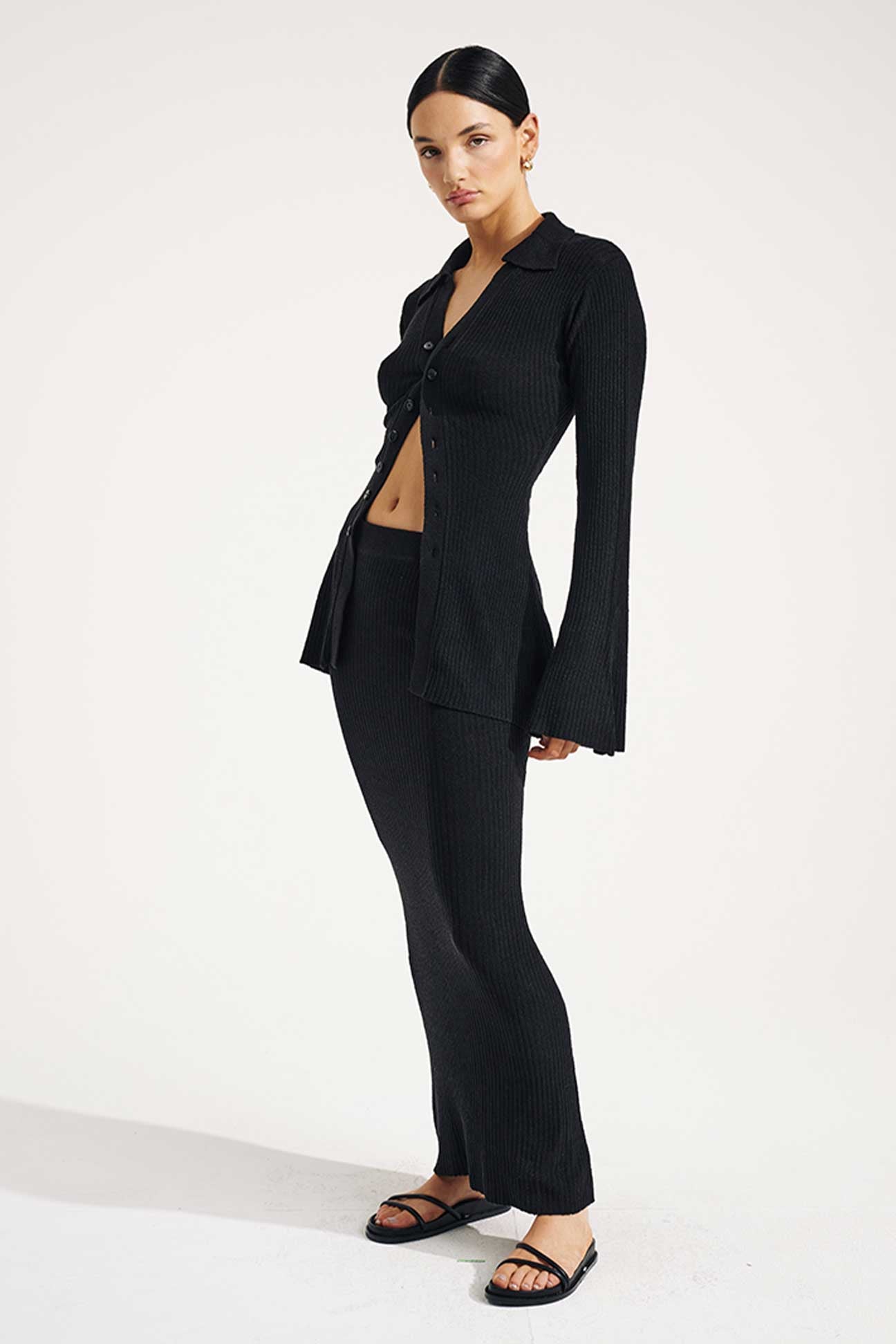 Woman wearing a black suit on a white background
