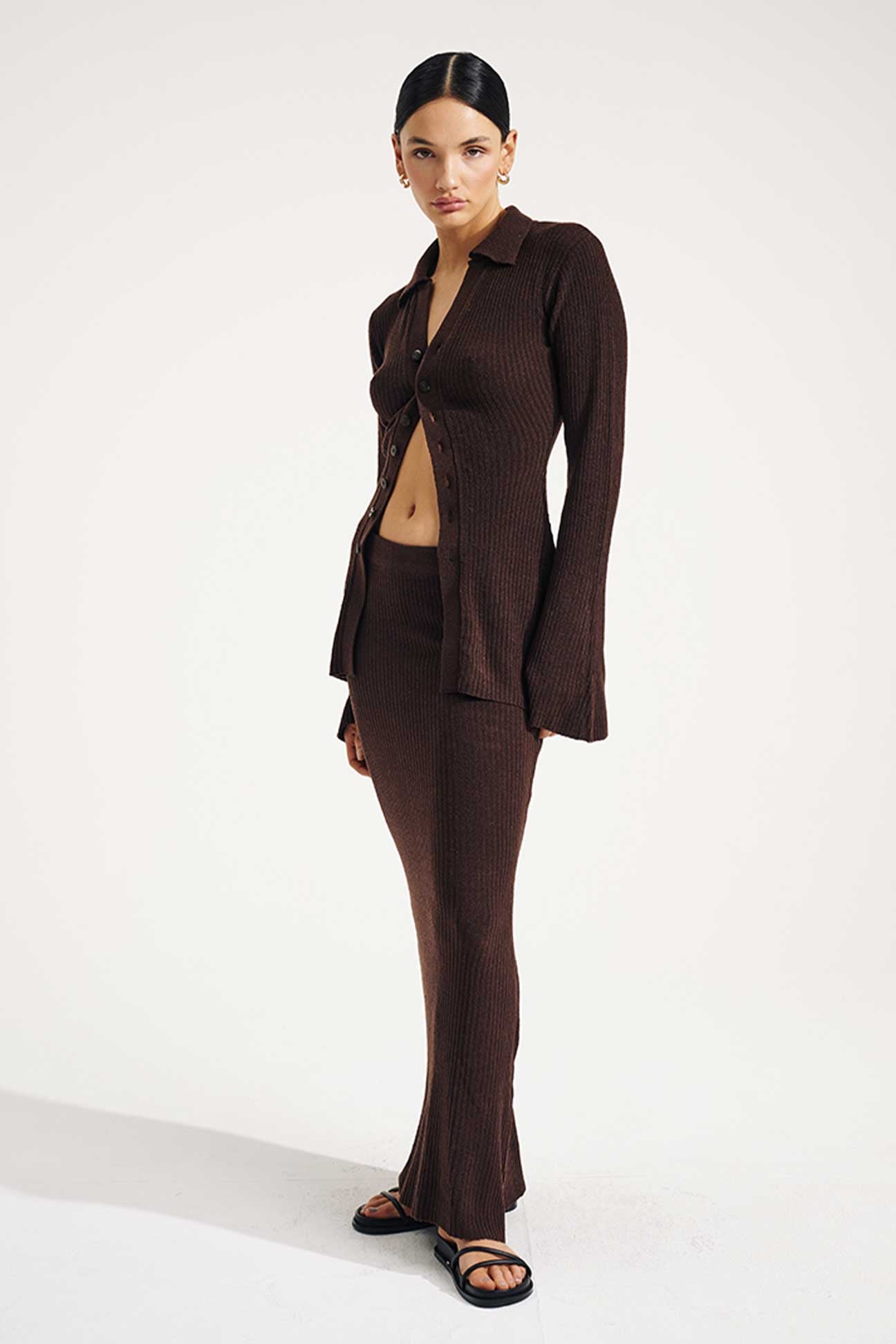 Woman wearing a brown suit on a white background