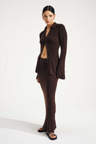 Woman wearing a brown suit on a white background