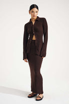 Woman wearing a brown suit on a white background