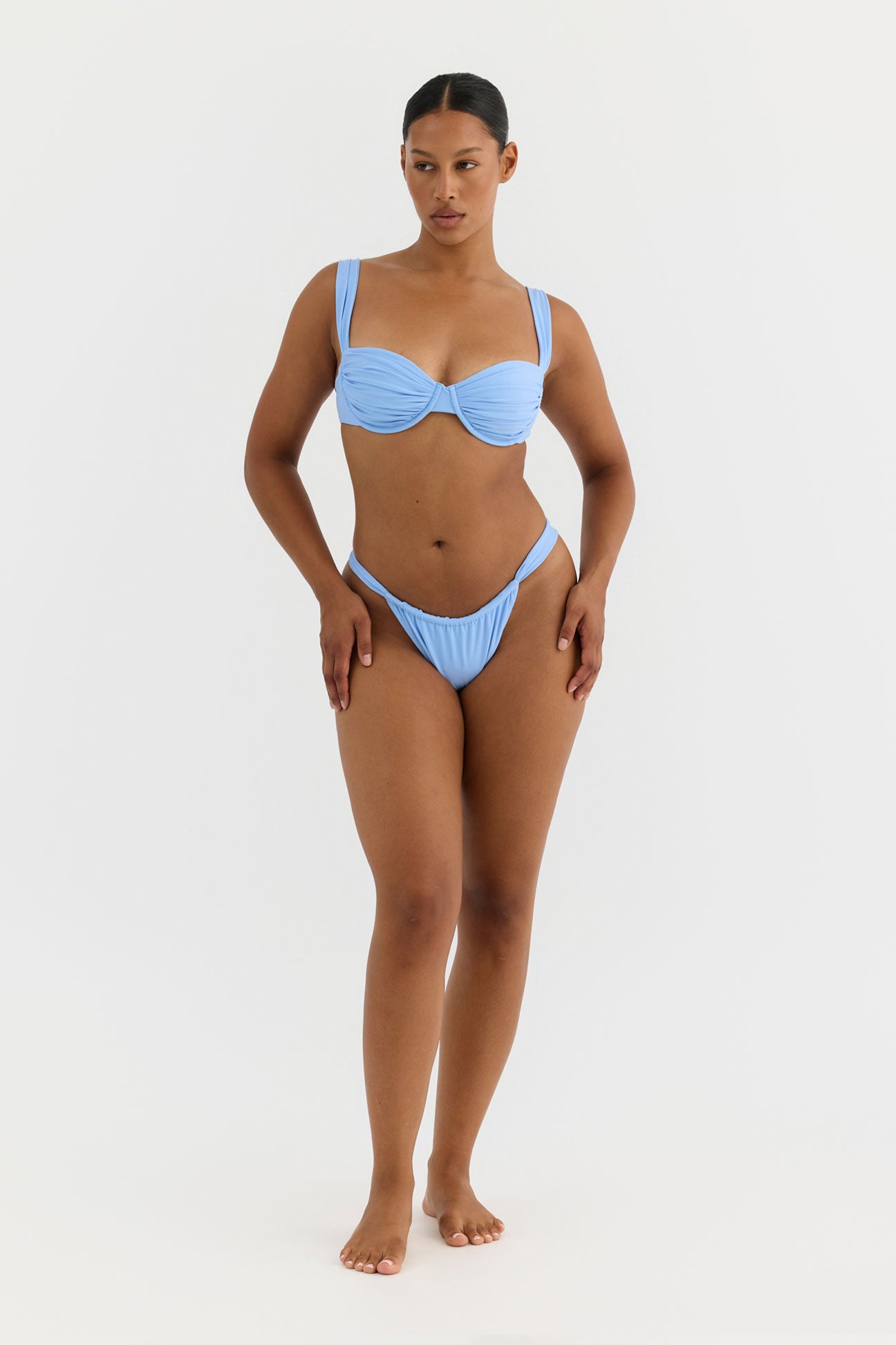 Woman wearing a blue bikini on a white background