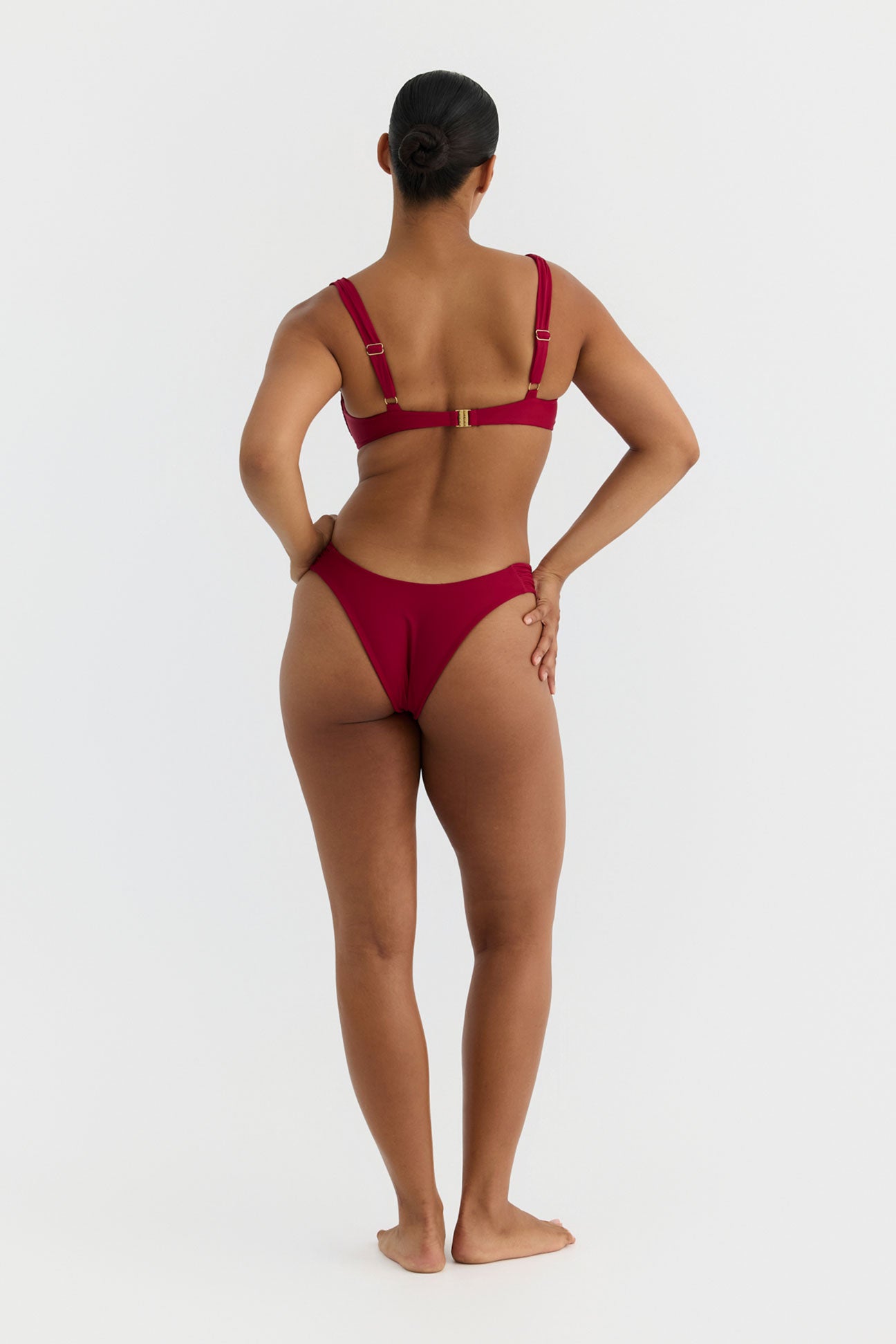 Person wearing a red bikini set on a white background