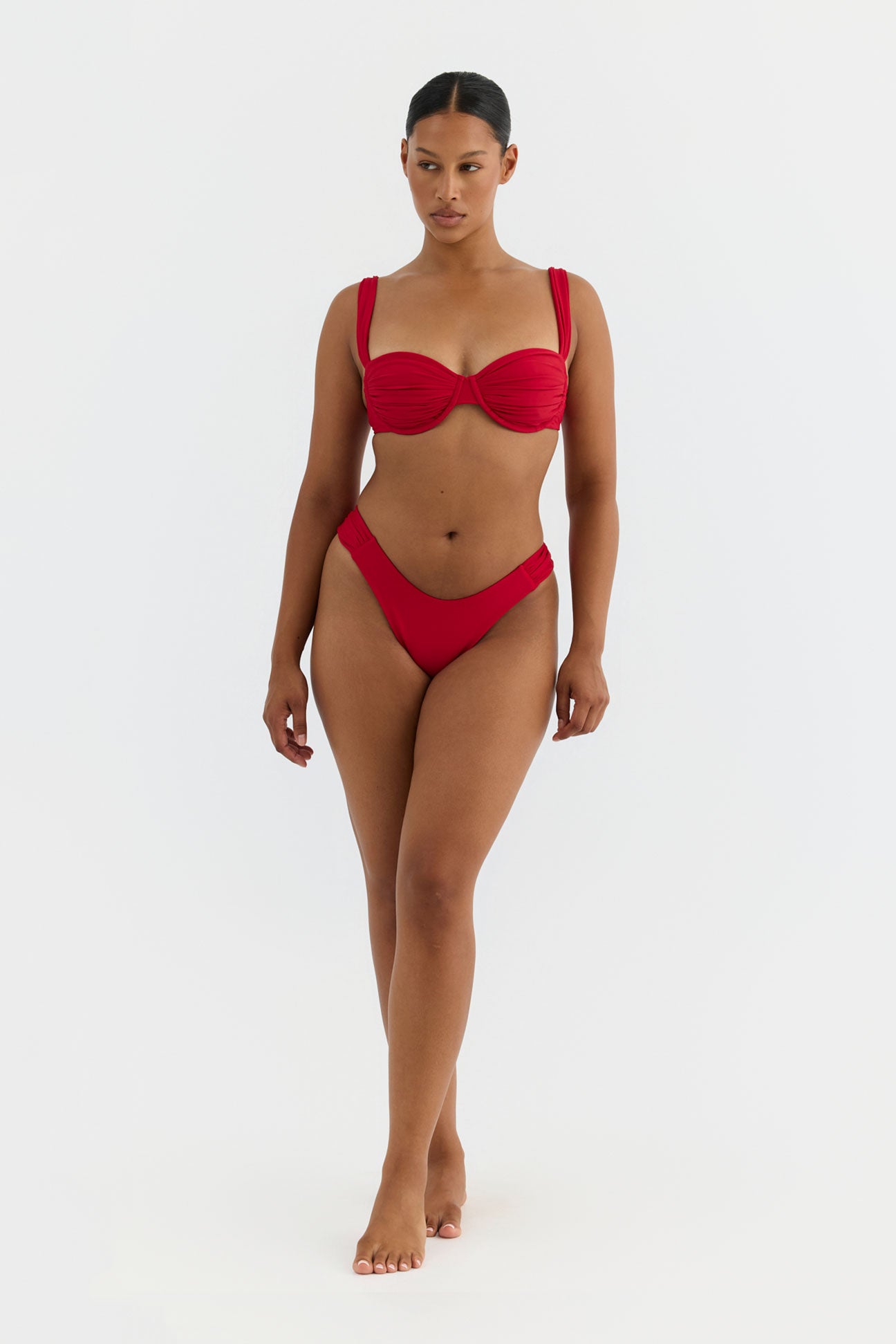 Woman wearing a red bikini on a white background