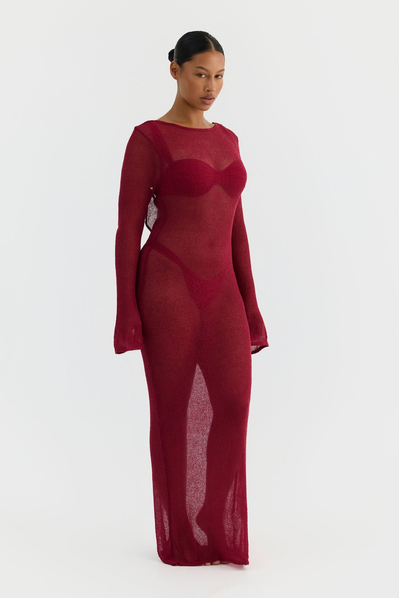 magenta sheer dress worn by a model on a white background