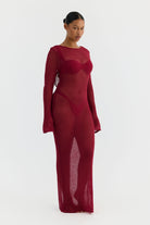 magenta sheer dress worn by a model on a white background