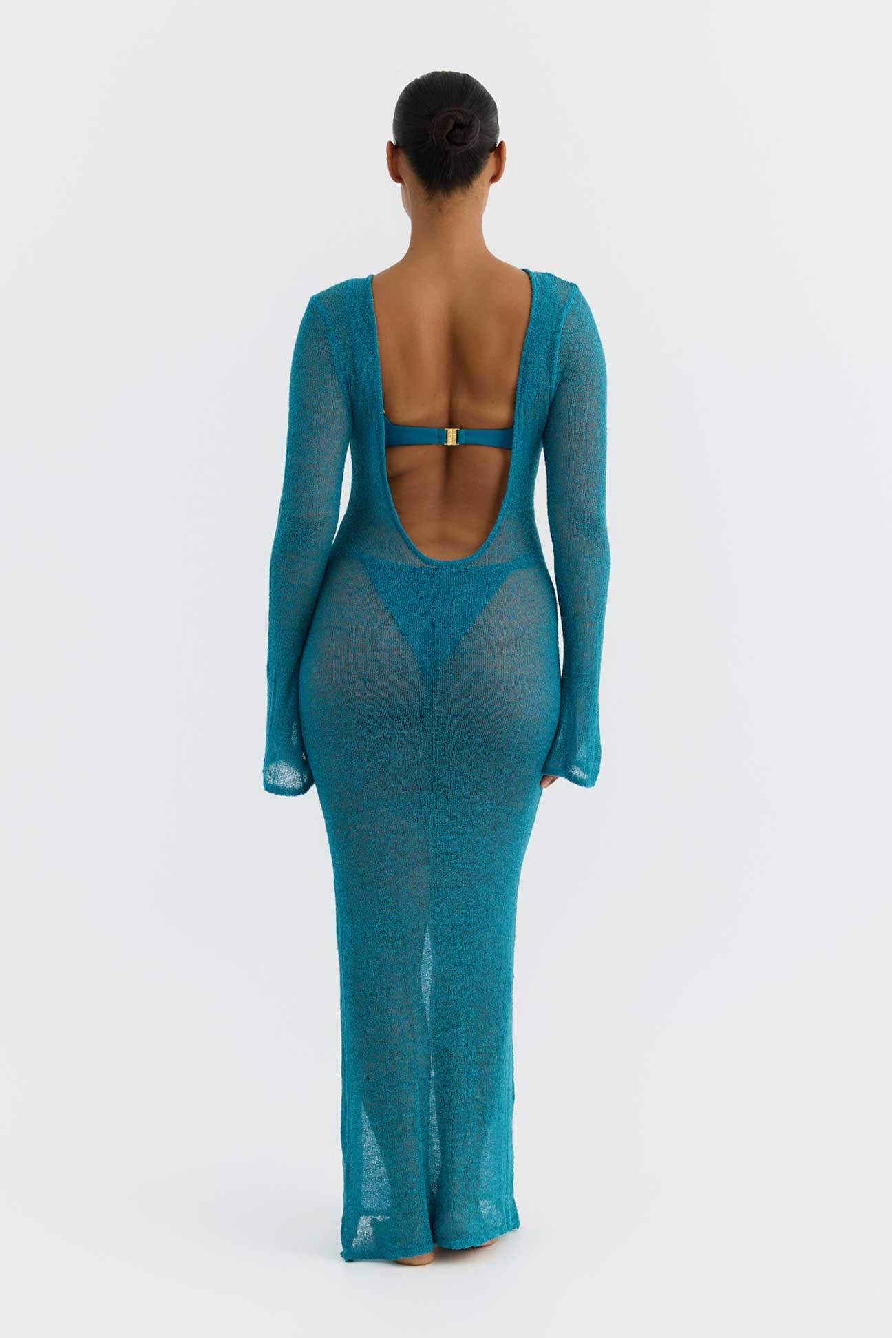 Teal dress with open back on a white background
