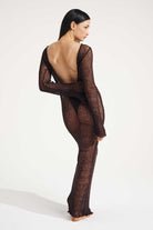 Model wearing a brown dress on a white background