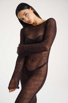 Model wearing a sheer brown long-sleeve dress against a white background