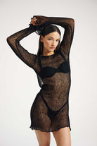 Woman wearing a black dress on a white background