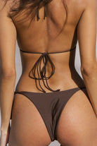 Brown bikini with thin straps on a neutral background