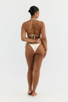 Woman wearing a beige bikini on a white background