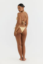 Woman wearing a yellow bikini on a white background