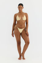 Woman wearing a yellow bikini on a white background