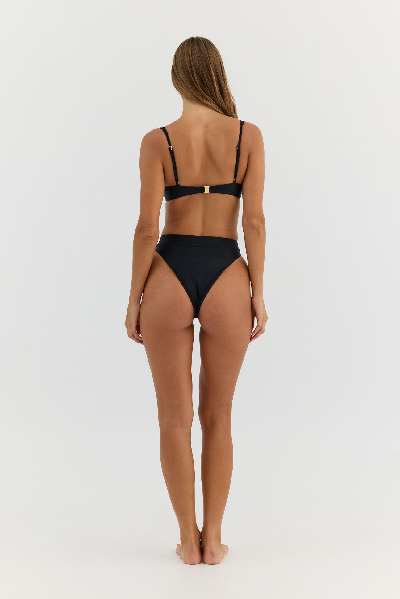 Person wearing a black bikini on a white background
