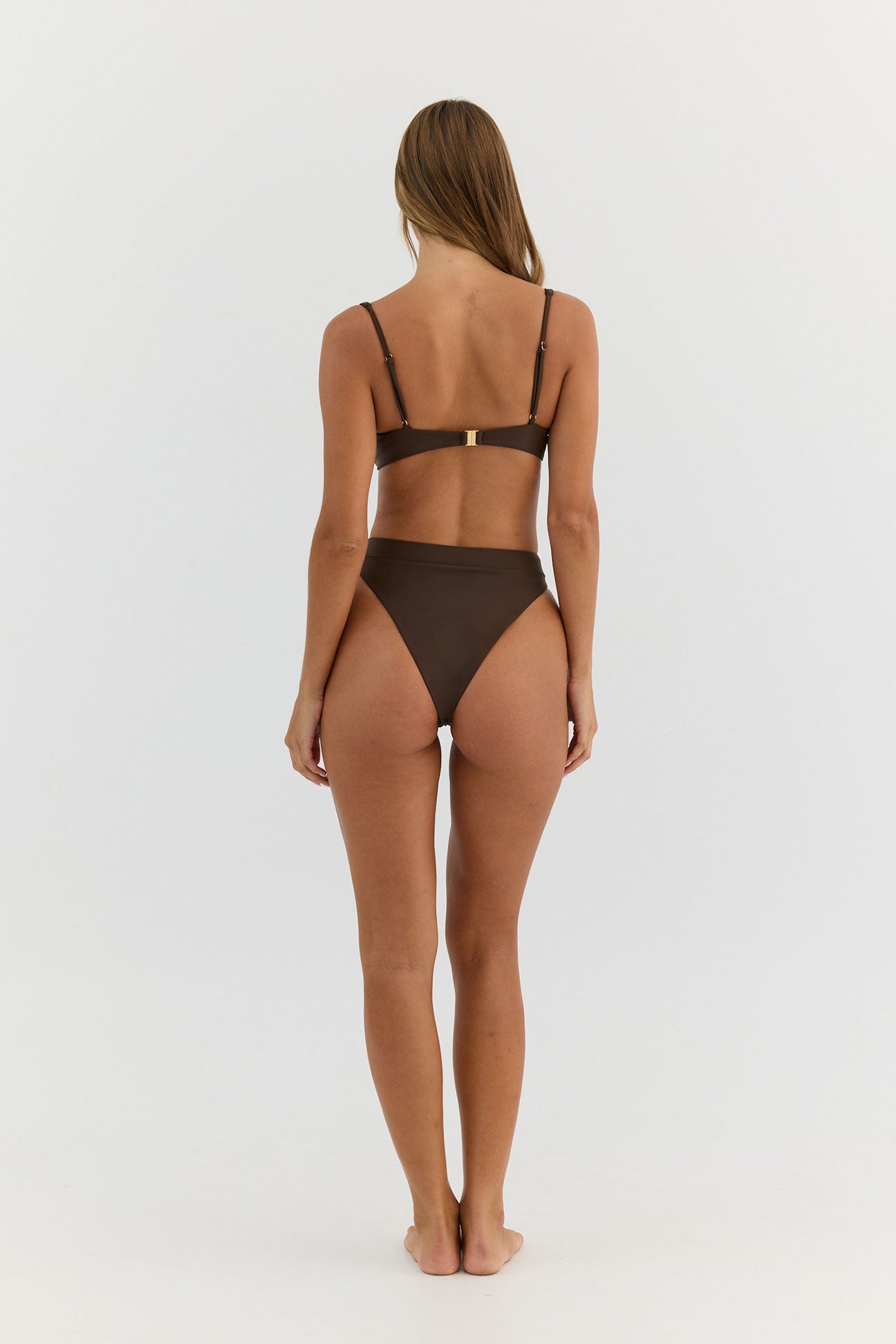 Woman wearing a brown bikini on a white background