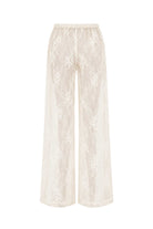 A pair of wide-leg cropped pants in a warm cream or ivory lace fabric, featuring an elastic waistband and a delicate floral lace pattern, shown against a plain white background.