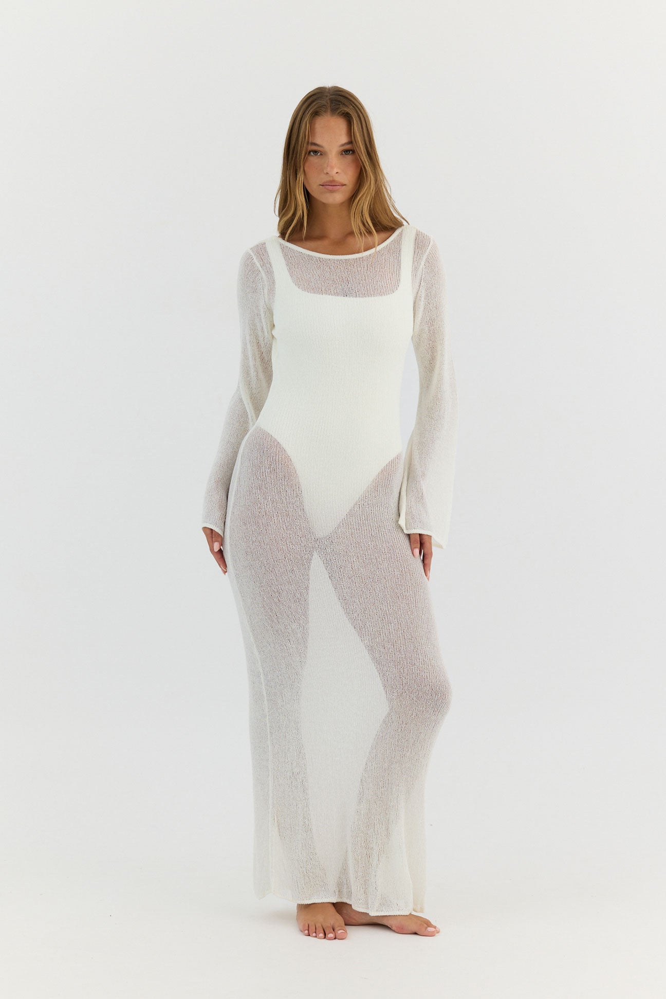 Woman wearing a sheer white outfit on a white background