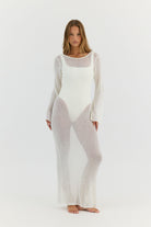 Woman wearing a sheer white outfit on a white background