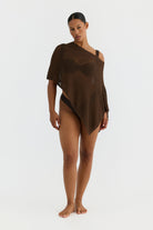 Woman wearing a brown one-shoulder top on a white background